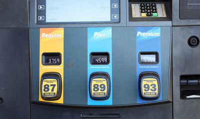 gas pump stands outside a hospital, representing rising fuel costs impacting healthcare budgets,...