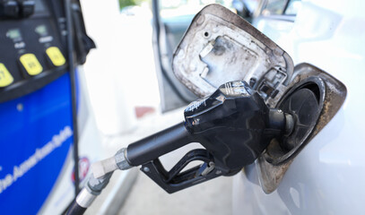 gas pump stands outside a hospital, representing rising fuel costs impacting healthcare budgets,...