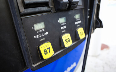 gas pump stands outside a hospital, representing rising fuel costs impacting healthcare budgets,...