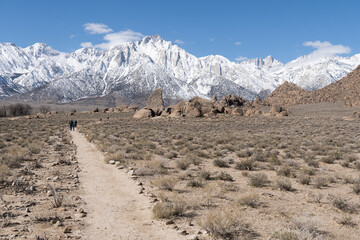 Path leading towards snow-capped mountains, including Mount Whitney