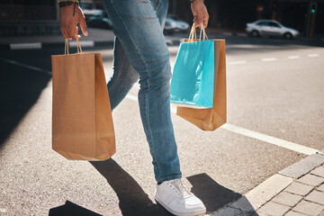 Legs, shopping bag and city person walking, travel and carry retail package, sales product and on...