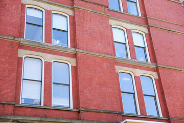 cityscape with a modern brick building, representing growth, commerce, and urban development