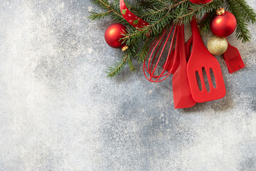 Mockup for recipe. Various red kitchen baking utensils Christmas on gray stone background. View...