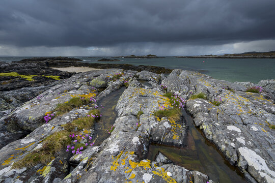 Scottish coast in spring with rain clouds over the ocean at Mallaig in Scotland, United Kingdom