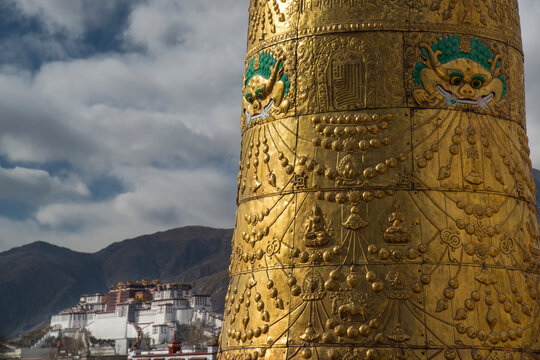 Porta Potola Palace past the giant prayer wheel atop the Jokhang temple; Lhasa, Tibet
