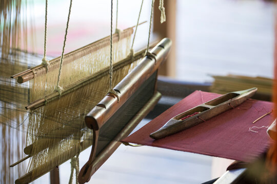 Stretched strands of fine yarn in traditional looms at Ock Pop Tock, the living craft center; Luang Prabang, Laos