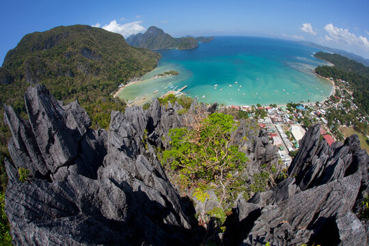 An Aerial Fisheye View From The Top Of Sharp Limestone Spires Overlooking The Village Of El Nido; El Nido, Bacuit Archipelago, Palawan, Philippines