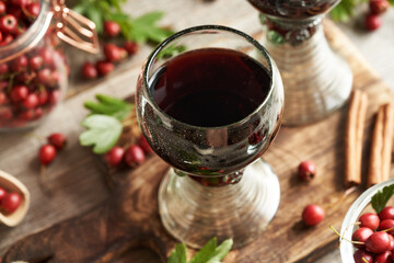 Medicinal wine made of fresh hawthorn berries on a table