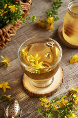 Fresh St. John's wort flowers in a cup of herbal tea
