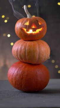 Halloween pumpkin piramid with smoke rising from eyes 