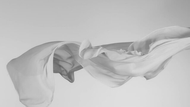 Super Slow Motion of Waving Transparent Cloth. Filmed on High Speed Cinema Camera Phantom VEO 4K, 1000 fps. Isolated on White Background.