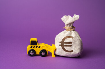 A bulldozer pushes a euro money bag. Ineffective use of funds. Money down the drain. Wasted...