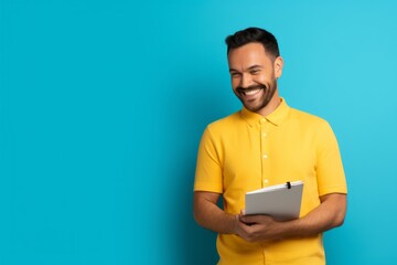 Inspired Thoughts: Man with Notebook Against a Yellow Background