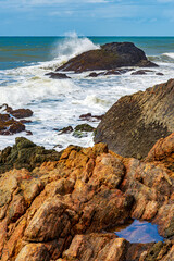 Waves crashing against the rocks in Serra Grande on the coast of the state of Bahia