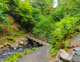 Female Hiker on Wooden Bridge at Latourell Falls at Guy W. Talbot State Park, Columbia River Gorge, Oregon, USA