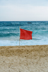 Red flag on a beach of Sarti, Greece