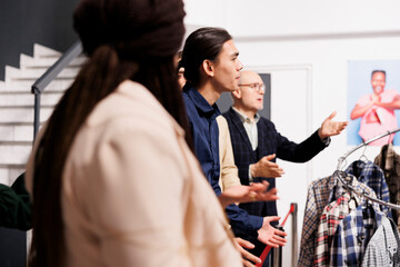 Diverse people customers arguing with clothing store staff while waiting in line for sales. Angry...