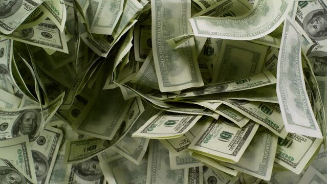 Super Slow Motion Shot of Hundred Dollar Banknotes Falling Down on Table at 1000fps.