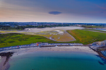 Aerial view on Silverstrand beach and car park in Galway city, Ireland. Popular tourist place with stunning view on Galway bay and Burren mountains. Blue hour.