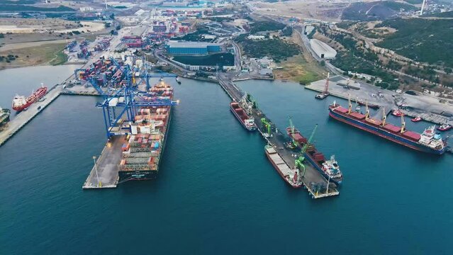 Cargo ships loading and unloading in commercial cargo sea port, Aerial view of business logistic import and export freight transportation by container ship