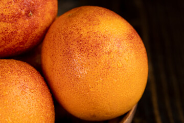 yellow-red orange peel covered with water drops