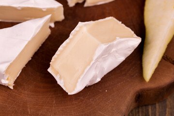 soft cheese with white mold on the board