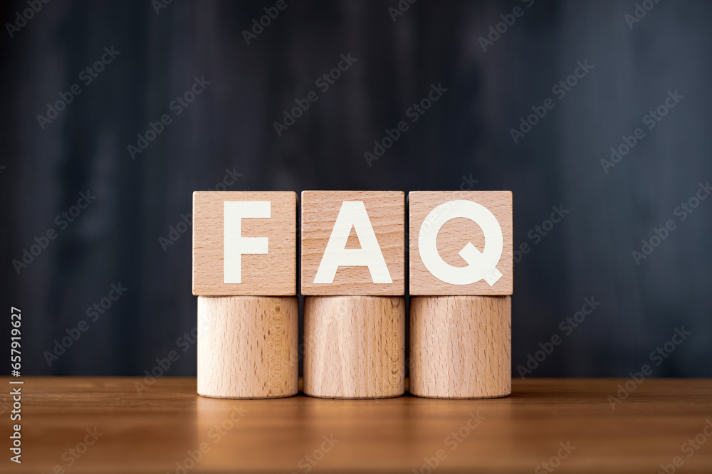 Poster there is wood cube with the word faq. it is an abbreviation for frequently asked questions as eye-ca