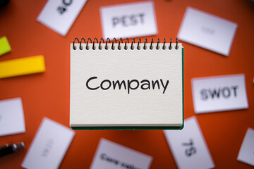 There is notebook with the word Company. It is as an eye-catching image.