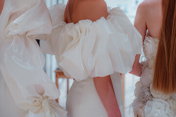 Elegant fashion details of white satin bridal dresses with puffy sleeves. Side view. Wedding...