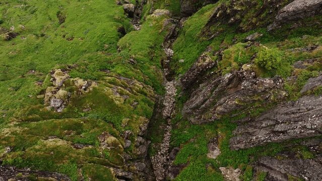 Lofoten islands' coastal beauty - aerial view from mossy mountain wall.