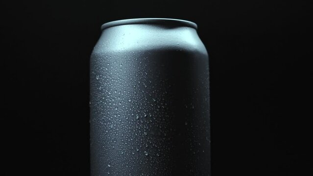 soda can spinning with water drops on its surface