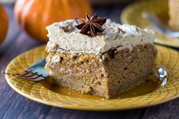 A slice of pumpkin spice latte cake with espresso frosting, ready for eating.