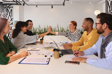 Team of employees working together at table in office. Startup project