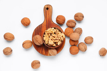 Bowl with walnuts on white background