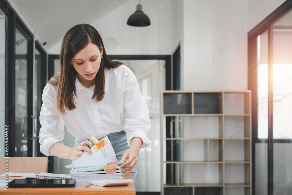Poster businesswoman working in stacks of paper files for searching and checking unfinished document achiev