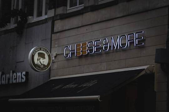 MAASTRICHT, NETHERLANDS - NOVEMBER 10, 2022: Selective blur on a logo of Cheese & More by Henri Willig on their store for Maastricht. Cheese and More is a chain of dutch cheese in Netherlands.