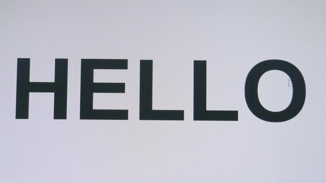 Typing the word HELLO on a keyboard revealed in monitor or sending a text message.