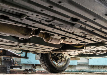 The bottom of a car at a service station