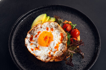 Breakfast waffles, fried eggs, avocado and salad