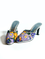 Purple flowers nyonya manek shoes or nyonya neaded shoes. A nyonya traditional shoes isolated in white background. Selective focus.