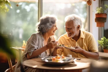 Foto op Canvas Caucasian senior couple cooking and having dinner together in kitchen house background. Old people cooking and making salad nutrition cuisine menu. © Virtual Art Studio