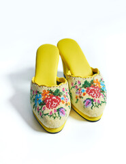 Yellow nyonya manek shoes or nyonya neaded shoes. A nyonya traditional shoes. Selective focus.
