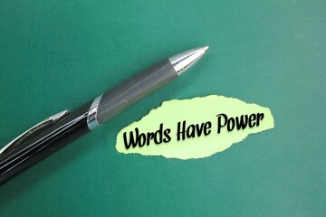 pen and torn colored paper with the words WORDS HAVE POWER