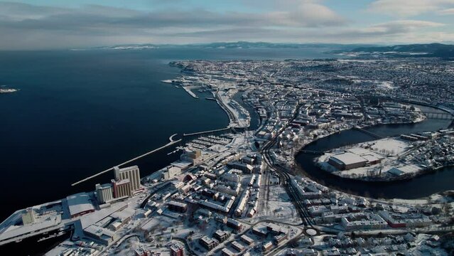 Drone Aerial View of Trondheim, Norway. City Harbor, Snow Capped Buildings on Sunny Winter Day
