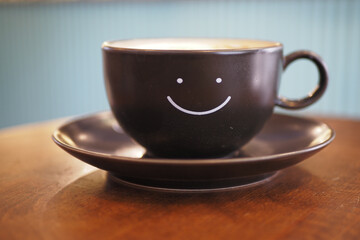 black coffee cup with smile shape design on it 