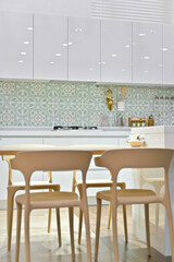 The newlywed couple's kitchen is generally white in tone and decorated with a bright feel