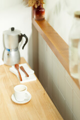 A comfortable room where warm afternoon sunlight
comes in through a window with a view of tree leaves