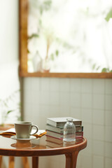 A comfortable room where warm afternoon sunlight
comes in through a window with a view of tree leaves