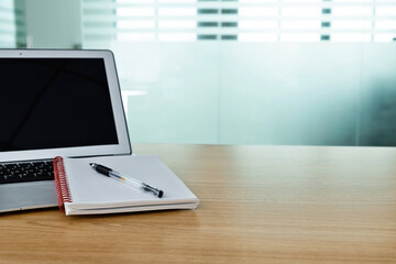 Blank notepad and laptop on the table
