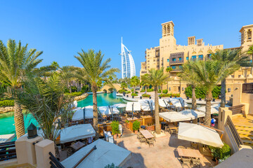 The canal, cafes and shops of the Souk Madinat Jumeirah, an upscale shopping market and mall in Dubai, United Arab Emirates - obrazy, fototapety, plakaty
